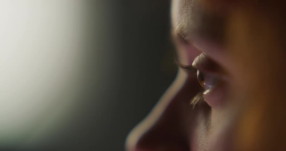 Side profile of woman with brown eyes looking