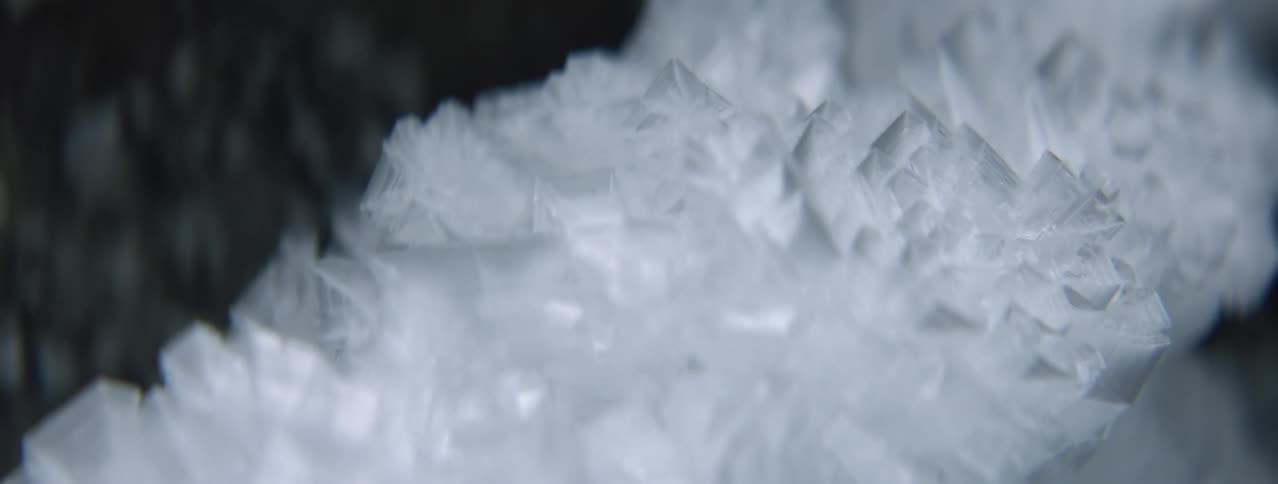 A crystalized pile of ice sits on the ground