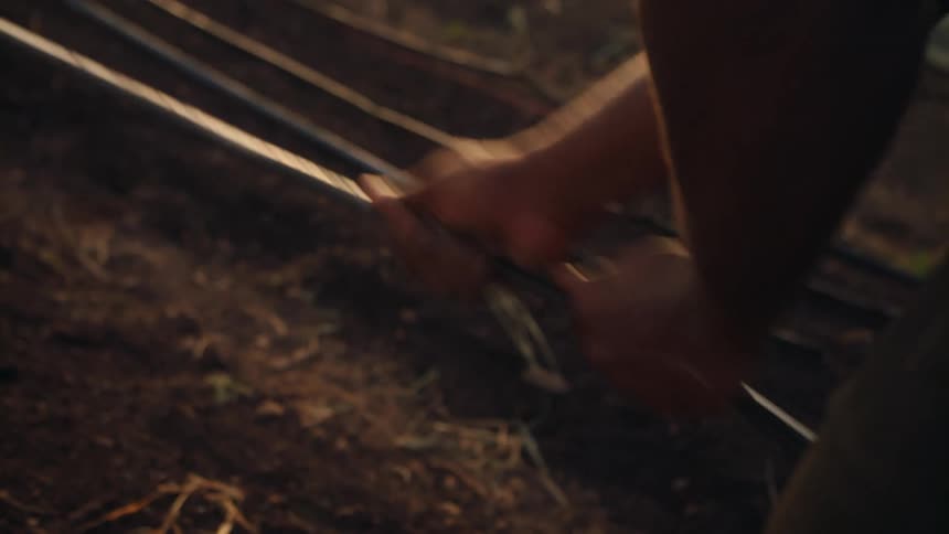 Man pulls cable over the ground to make sure they are secured at morning