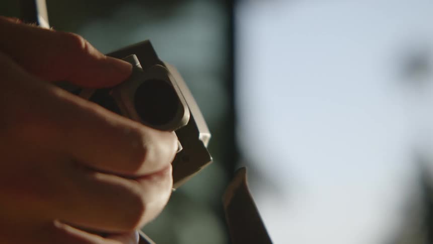 A man fiddles with the camera on his drone