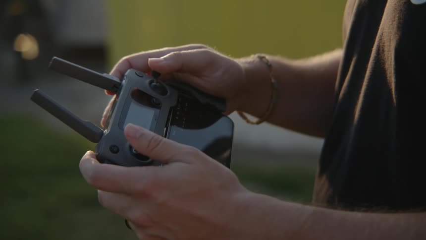 A man is using a drone controller