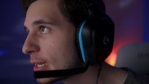 A man smiles as he talks in to a headset