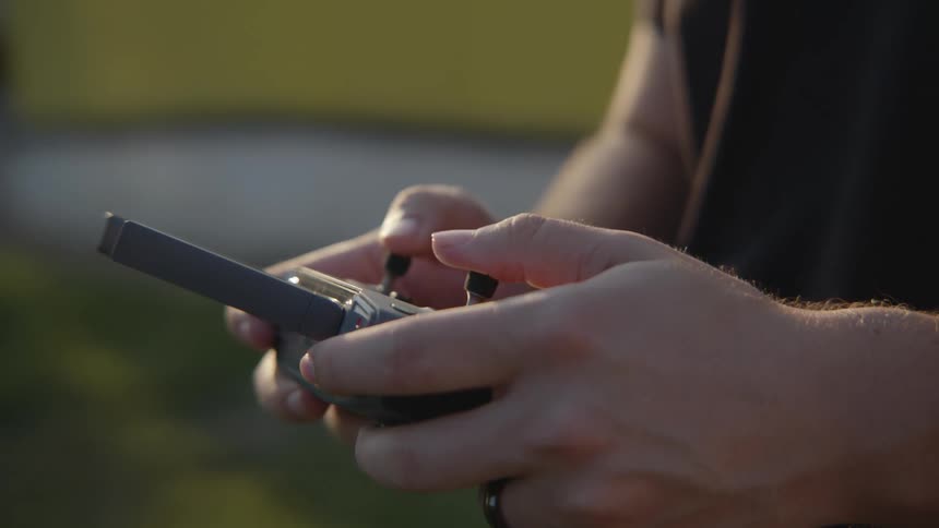 A person is using a drone controller