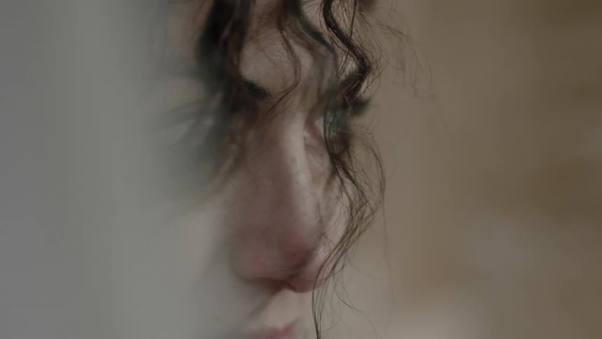 A white veil partially covers a woman's face
