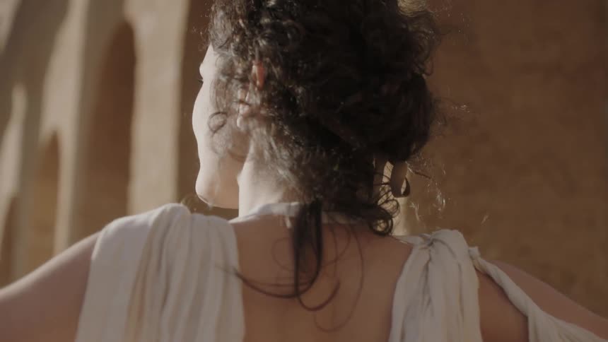 A woman is smiling with her arms outstretched