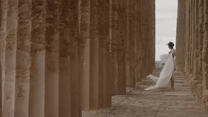 A woman holds her robes out to the sides