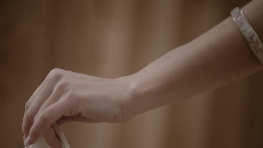 A woman is wearing a bracelet