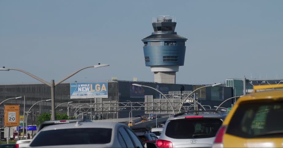 Cars and cabs traveling on a backed up highway past laguardia airport