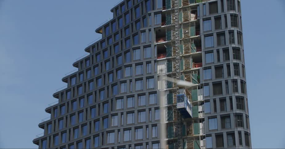 Facade of triangular building with windows in the city