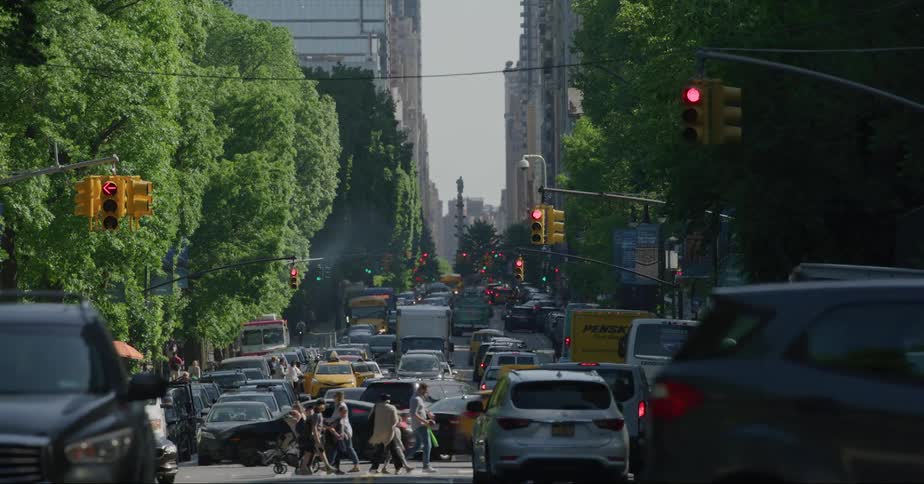 People and cars travel through the city