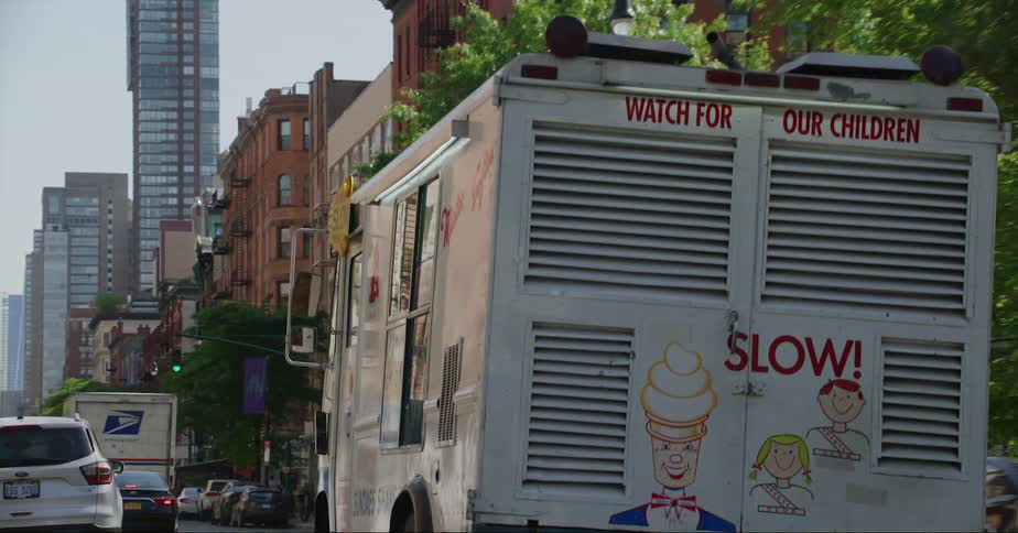 The ice cream truck drives in traffic