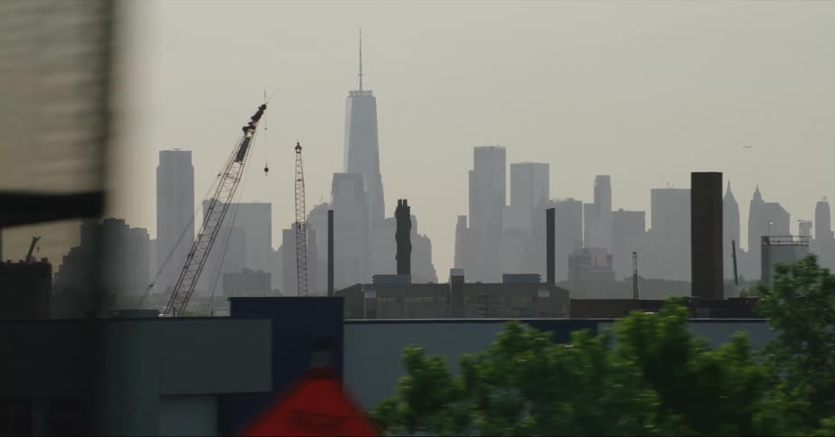 Skyscrapers loom over a metropolis in the evening