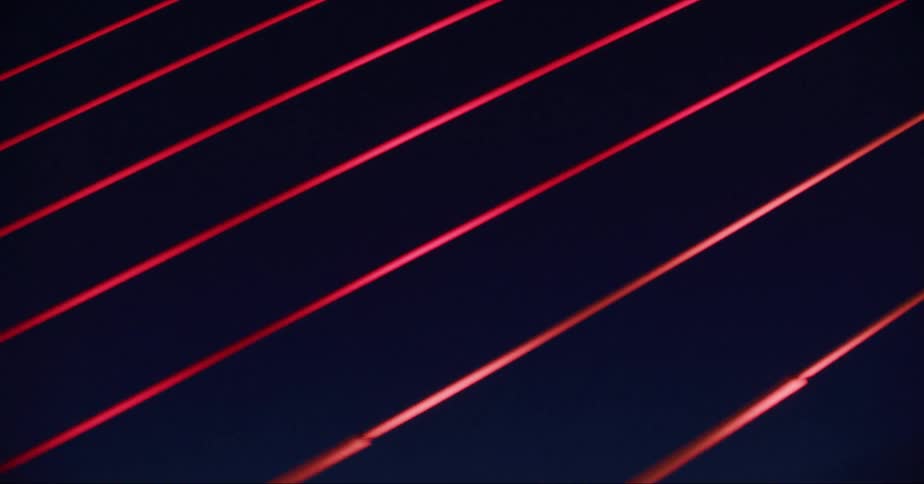 The red light reflects on the wire bridge