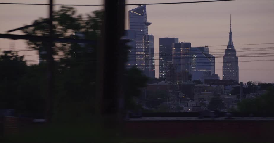 Skyscrapers loom over a metropolis in the evening