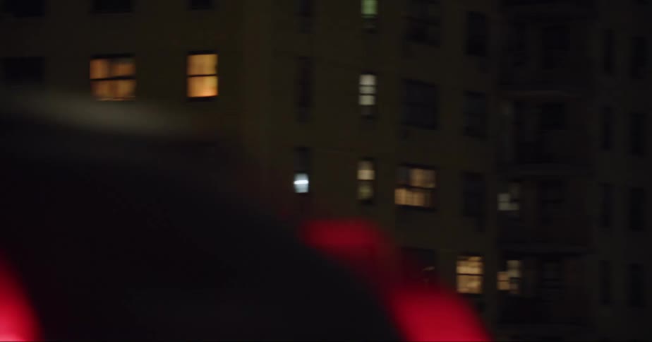 The buildings are lit up with multi colored lights at night