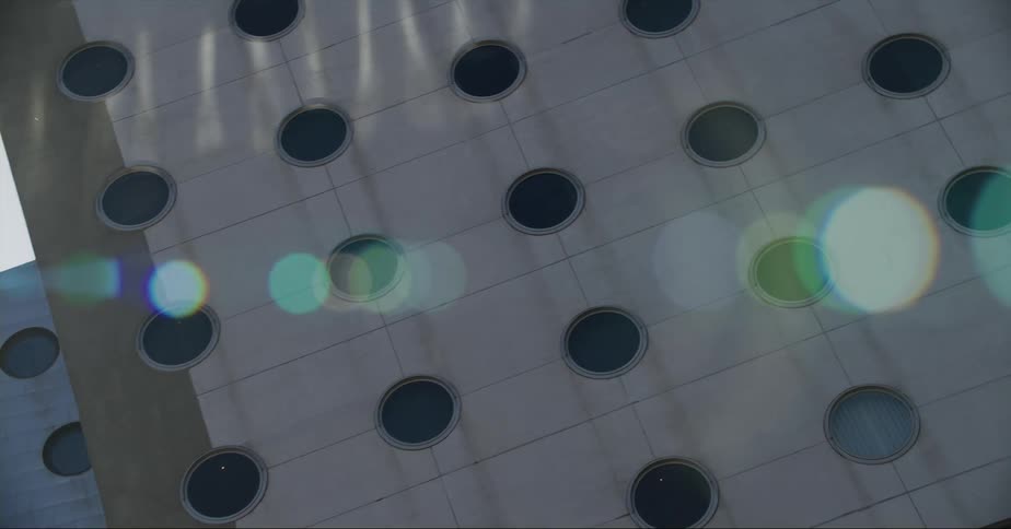 Building with circular windowsshows through camera glare