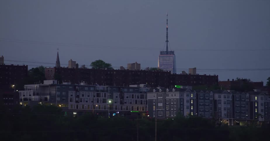 Tall skyscraper with tall antenna towers over surrounding buildings