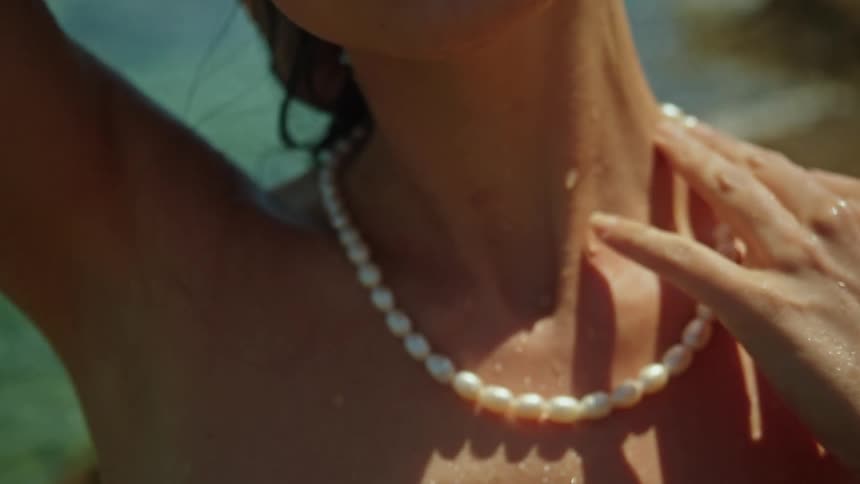 A woman is standing on the ocean coast