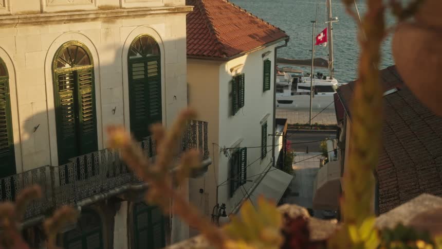 Buildings overlooking sea and sailboat in the coastal town