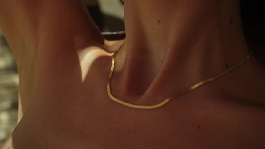 A woman is sun tanning outdoors during the day