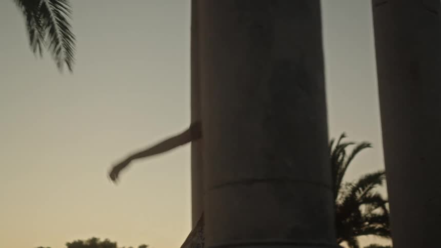 A woman is dancing by the pillars