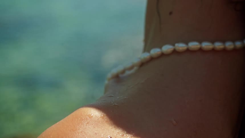 Close up view of a woman in the ocean is displayed