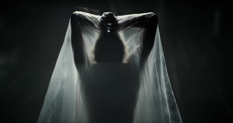 A woman stretches out under the plastic sheet