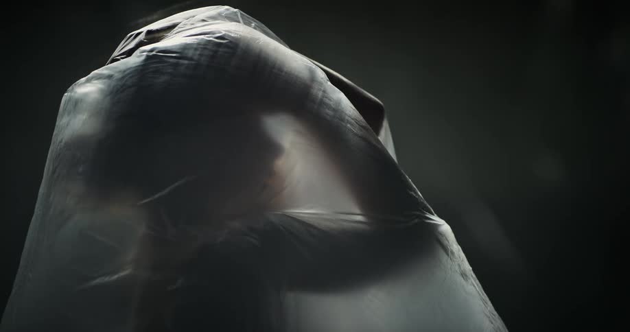 Femaleis silhouetted under film and moves through various poses