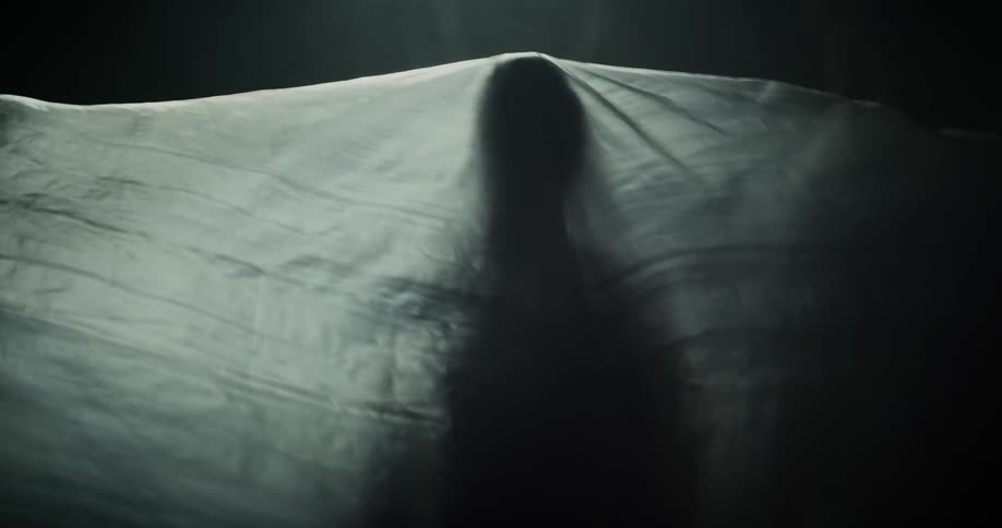 The sheet slowly falls over the person
