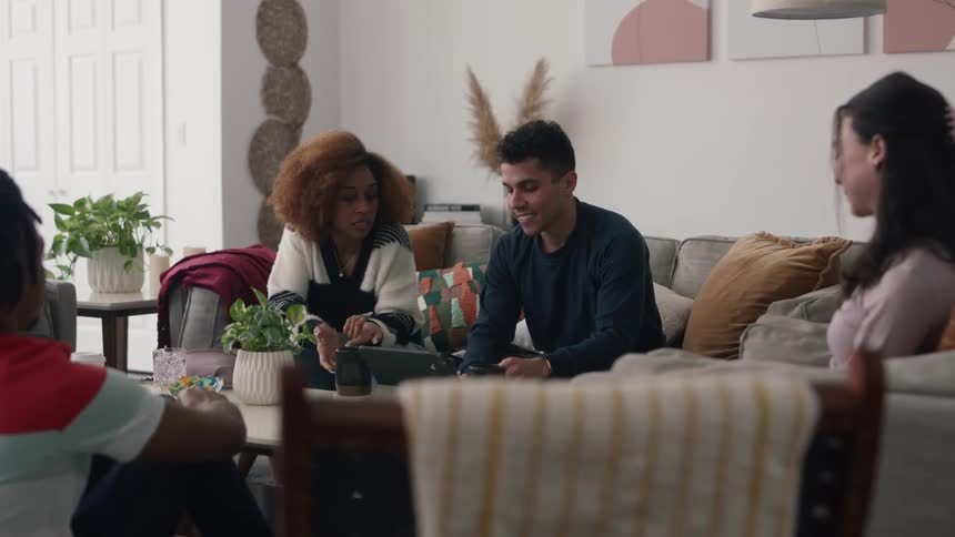 Friends talk and use a laptop