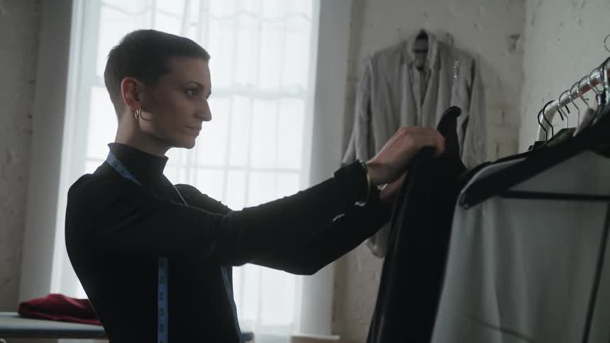 A woman looks at clothes from the rack