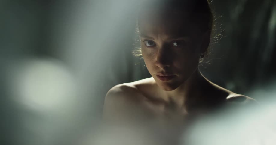 A nervous looking woman raises her head