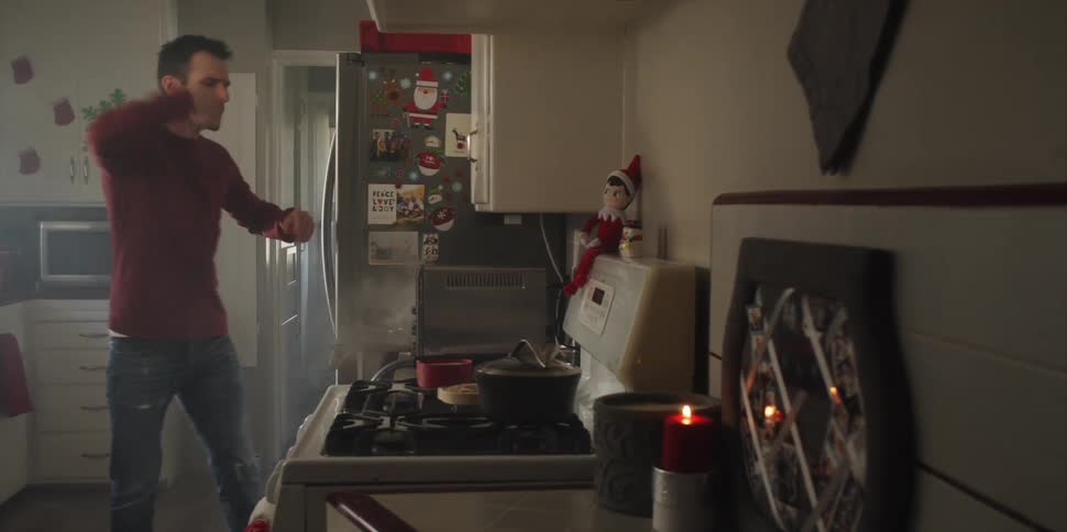 A man using his phone burns his food and his finger