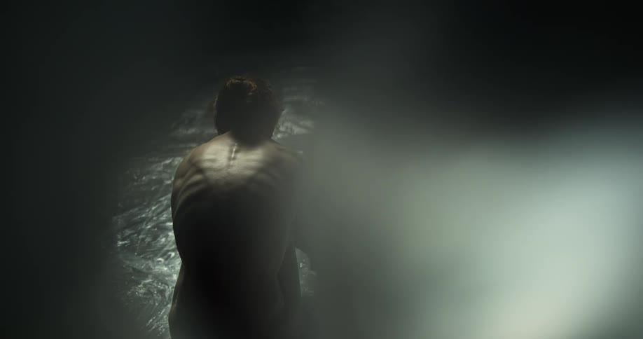A malnourished woman huddles under plastic wrap