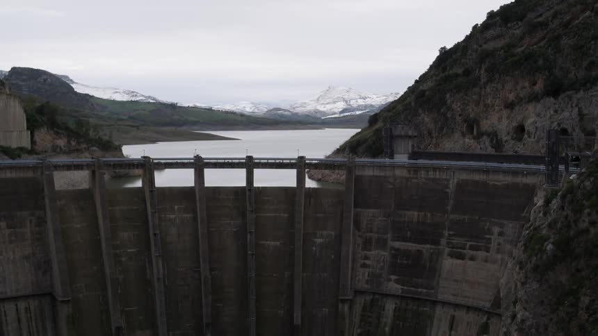 A large dam holding back the water of a mountain river