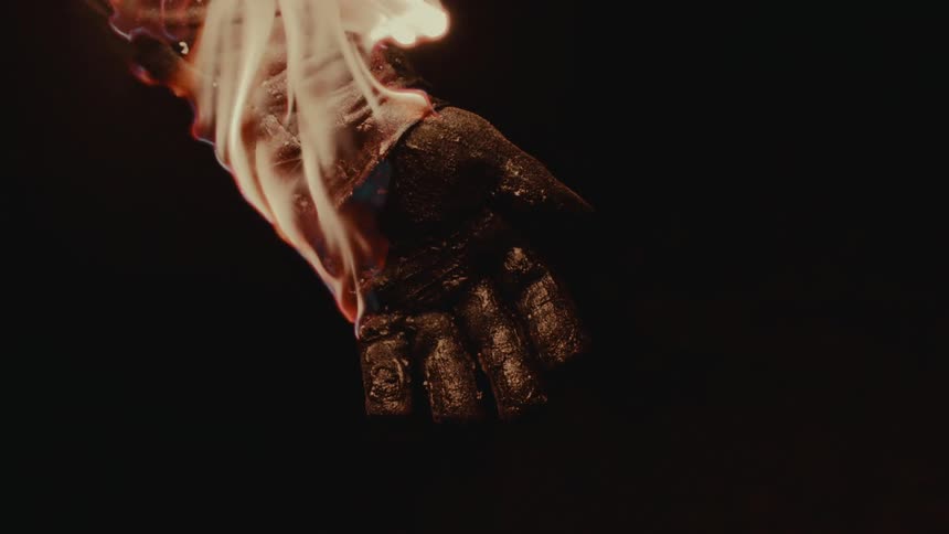 Flames moves down and engulf an arm and hand on fire