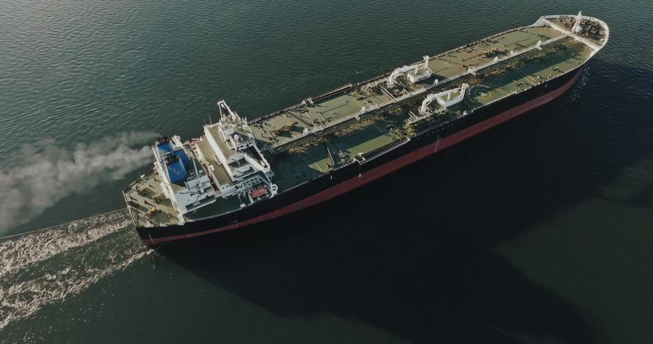 Aerial view of a ship moving on ocean water is displayed