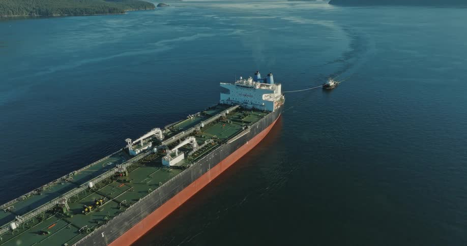 A large boat in the ocean with a small boat attached to it