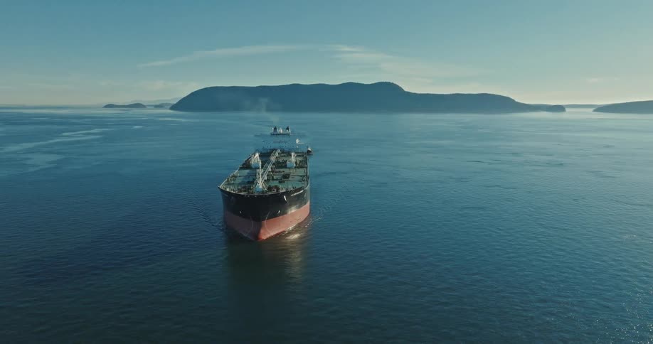 A large freight ship travels in the blue water