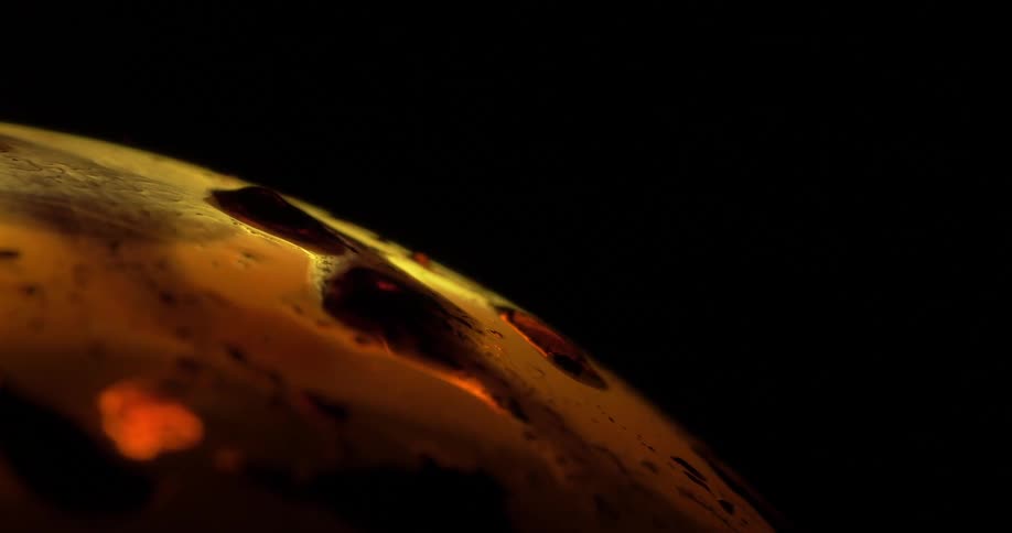 Orange grains on a curve against a black background