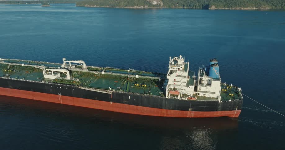 A large freight ship moves in the water