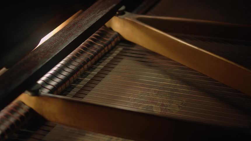 Wire sits in neat rows in a wooden piano