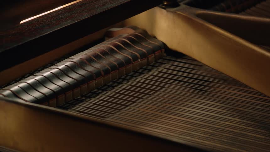 Keys inside of a piano moving up and down as it is played