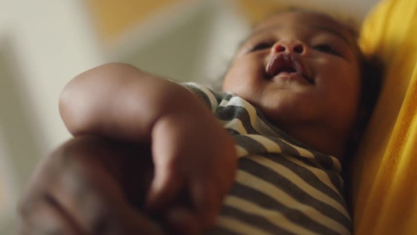 A man is holding his baby in his arms