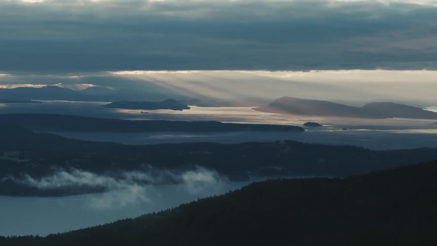 An oil tanker sails in the distance between the islands