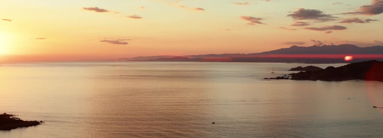 The sun sets over the Mediterranean sea, anamorphic flare
