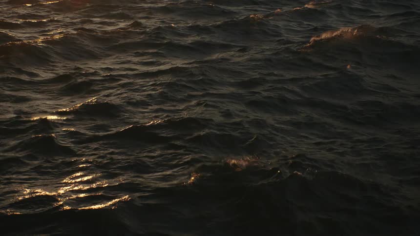 Small waves rippling and ruffling the ocean surface at evening