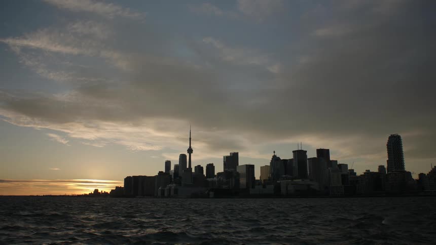 A city skyline with high rise office buildings off the shore
