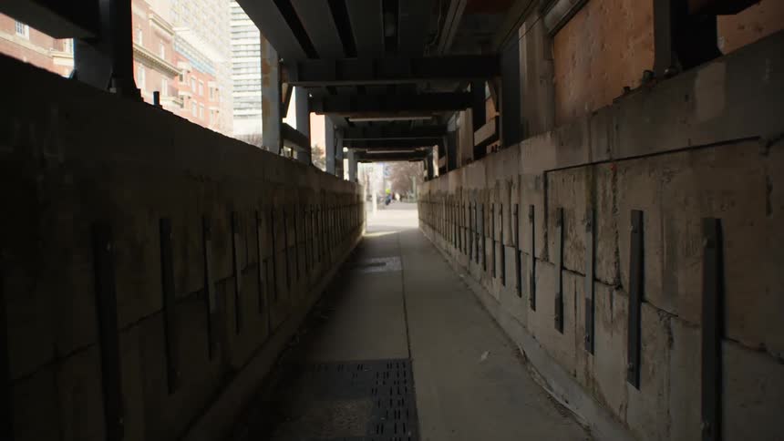 A covered city sidewalk downtown protecting pedestrians from building construction