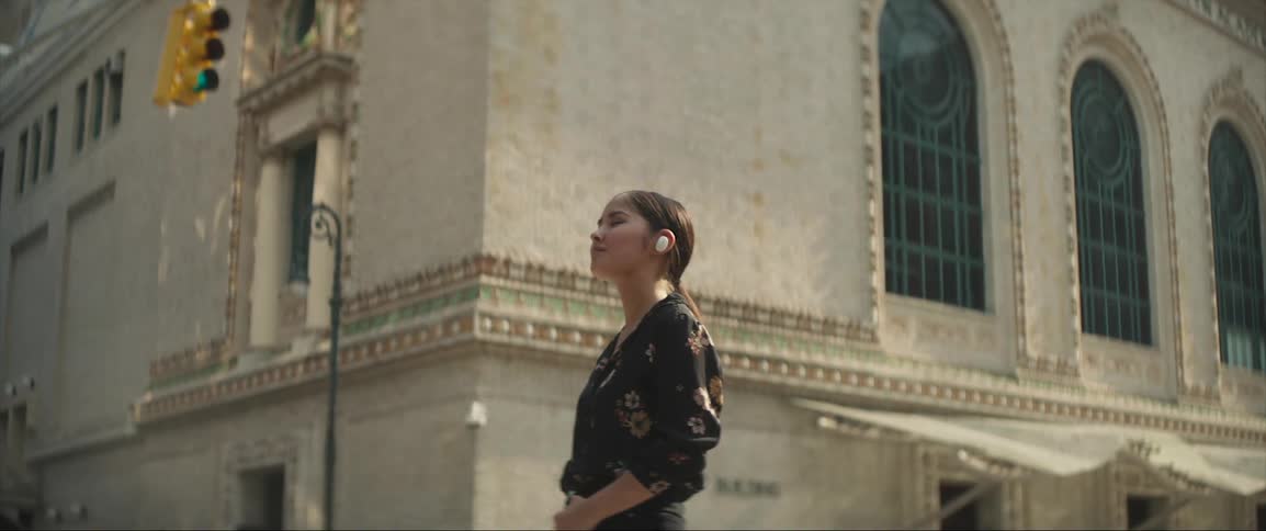 A woman is listening to music outside